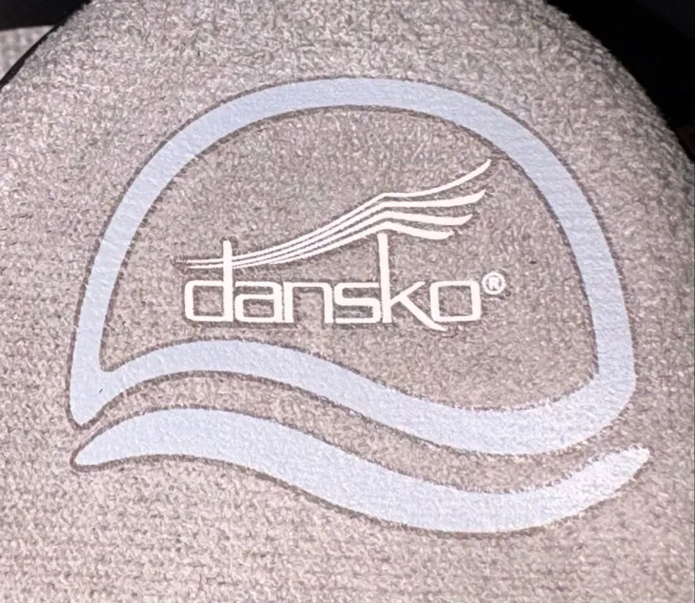 Dansko sandals, specifically the Sandi model featuring a black and white speckle